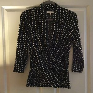 Low-cut fitted black with white polkadot blouse
